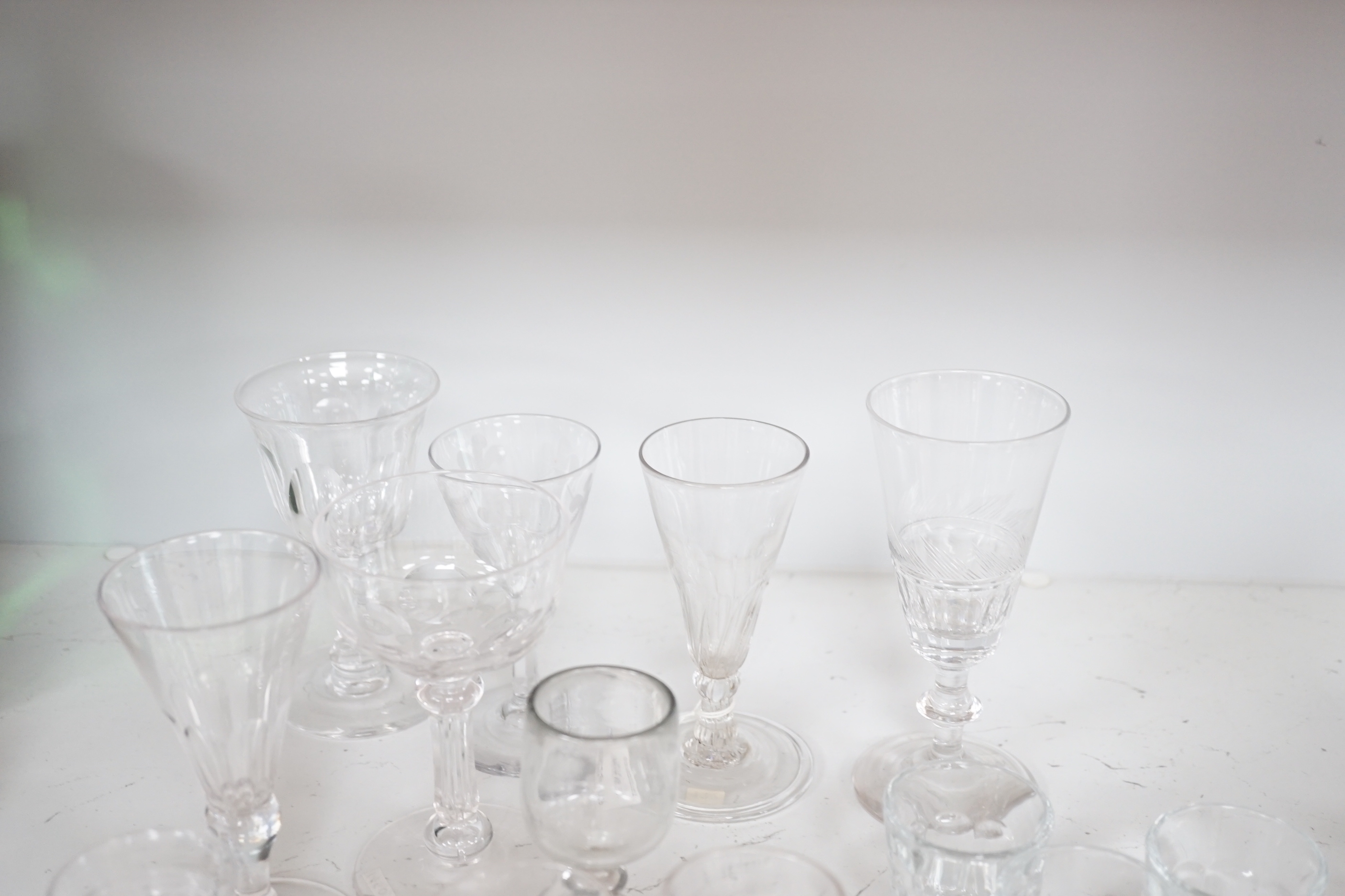 A collection of early 19th to early 20th century drinking glasses, including a set of twelve shot glasses, a set of six liqueur glasses, plus nine other wine, gin and sherry glasses of various sizes, tallest 14.5cm (27)